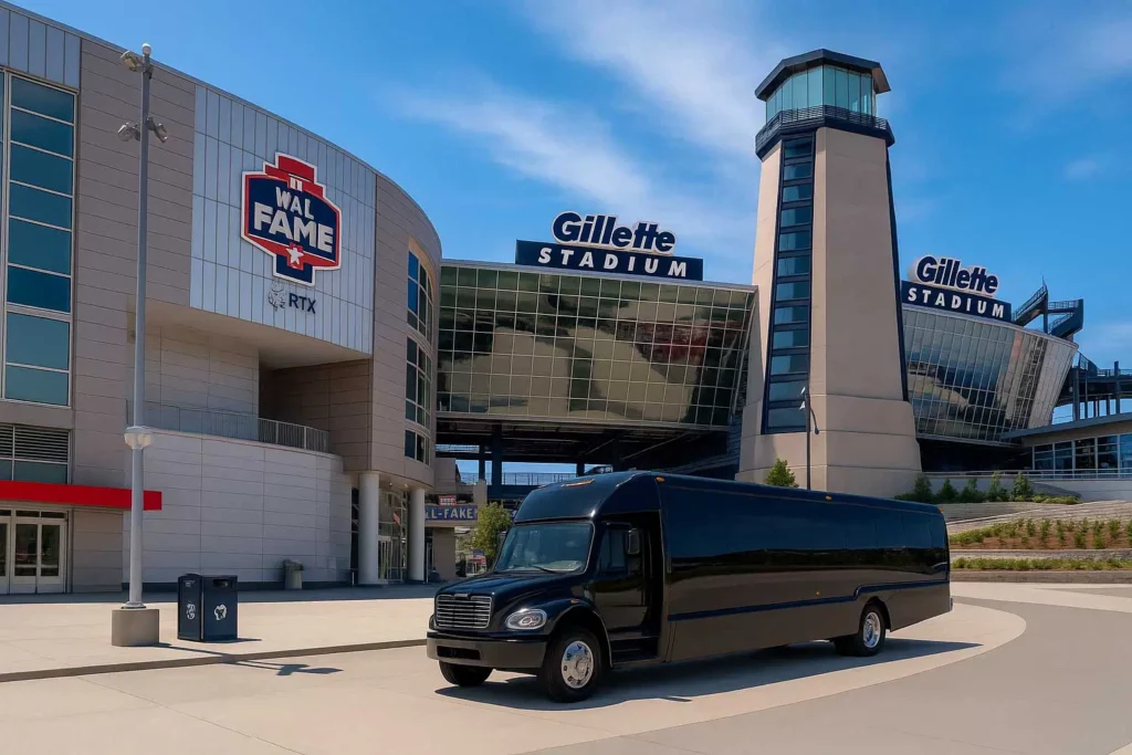 Black shuttle bus parked outside Gillette Stadium with the stadium entrance and lighthouse tower visible in the background.